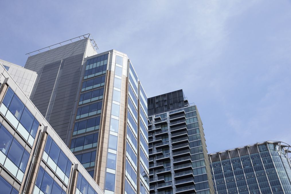 LONDON - MAY, 2017: Low angle view of modern glass fronted buildings against blue sky, City Of London, London